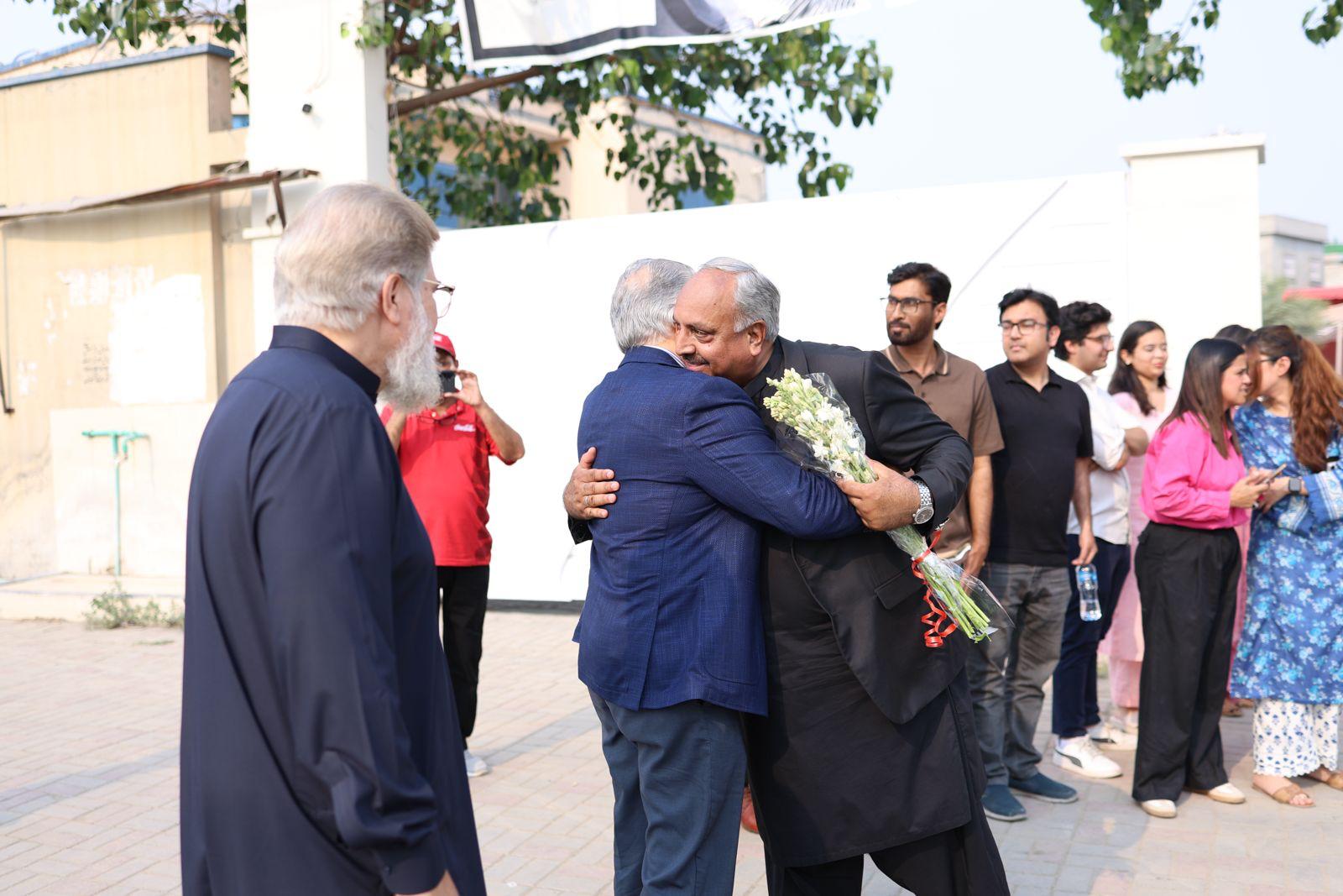 Guests embracing and greeting each other at a Barkat Group of Companies event